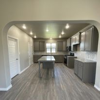 A kitchen with a large island in the middle of the room.