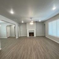 There is a fireplace in the middle of the living room.