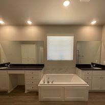 There is a bathtub in the middle of the bathroom.