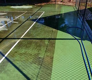 Wet tennis court — School Cleaners Mackay, QLD