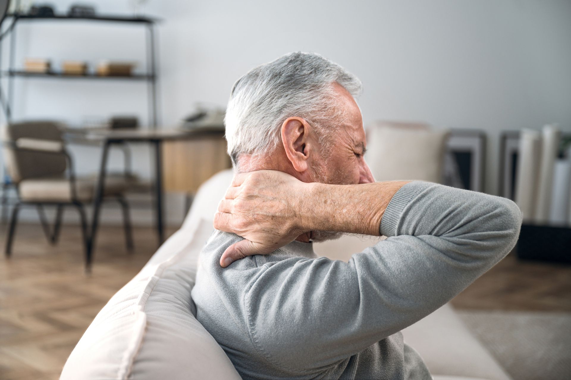 A man with a broken arm is sitting at a table with a doctor.