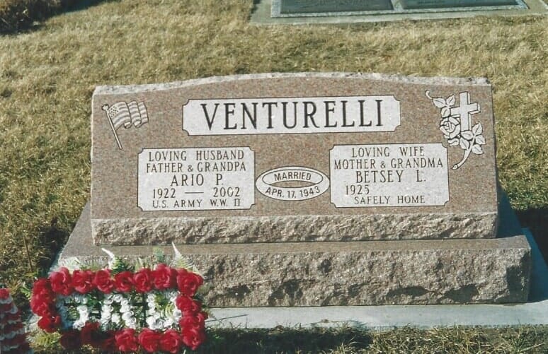 Tombstone for the Venturelli family. It has names, birth/death years. Includes a red floral arrangement.