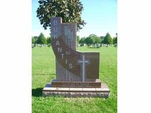 Monument in cemetery, brown granite, cross, 