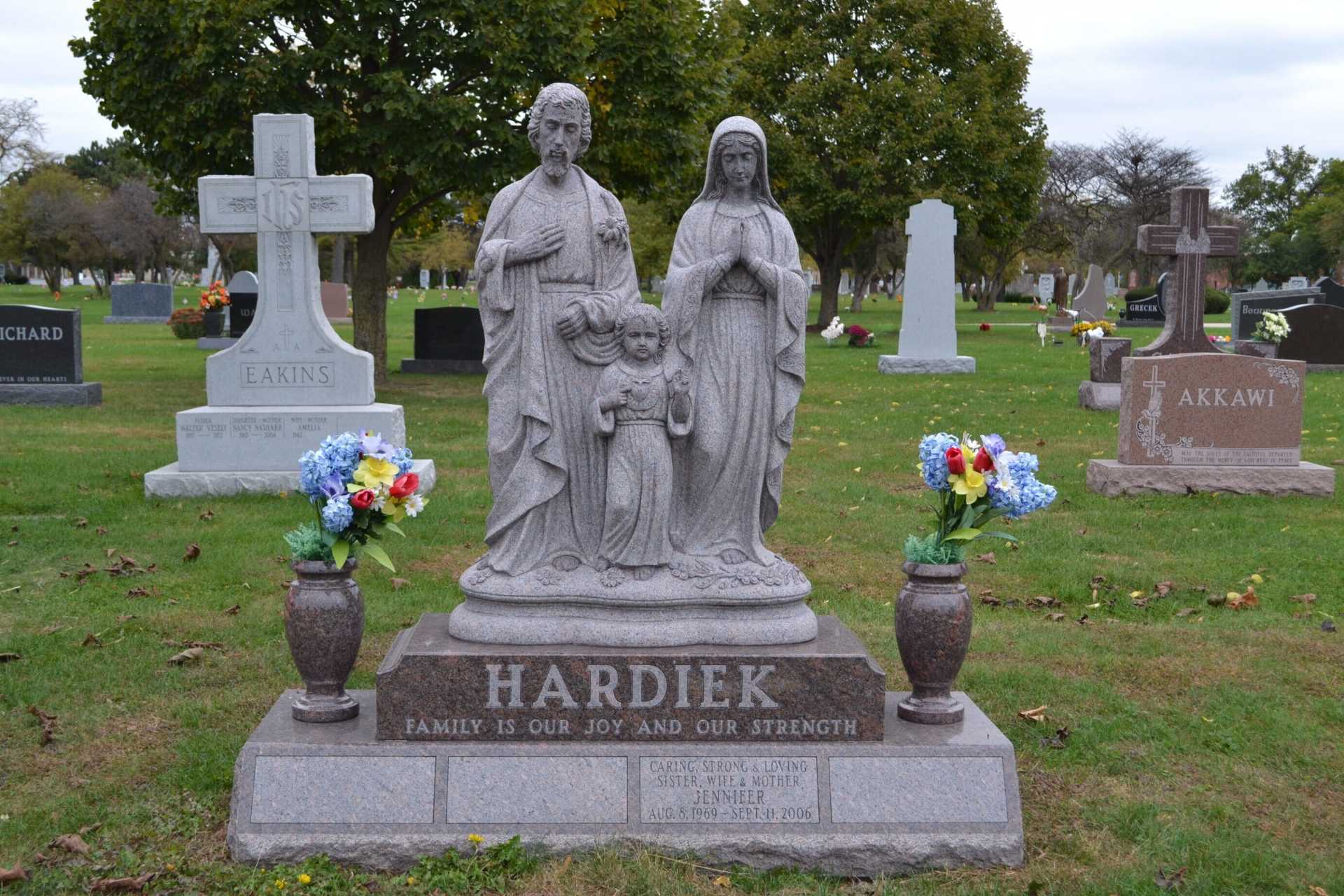Grave marker with a family statue, name 