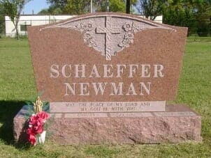 Red granite headstone with cross, names 