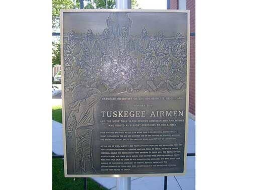 Bronze plaque of the Tuskegee Airmen, depicting men in uniform, likely outdoors.