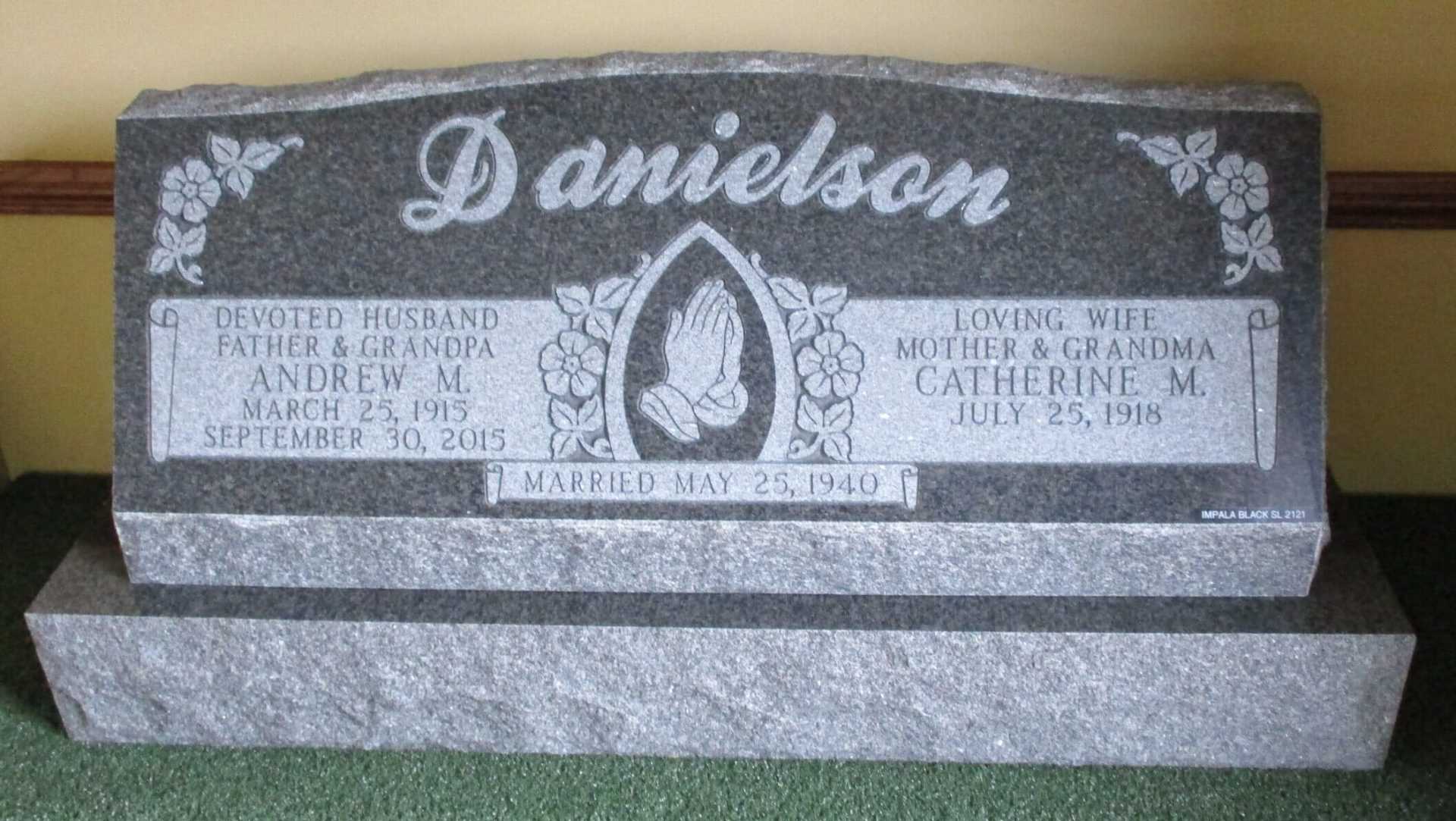 Gray headstone with Danielson name, praying hands, and names of Andrew & Catherine.