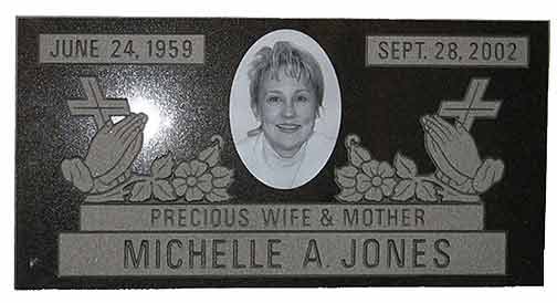 Headstone with a photo of Michelle A. Jones, dates, praying hands, and the inscription 