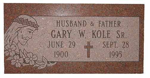 Gravestone of Gary W. Kole Sr., born June 29, 1900, died Sept. 28, 1995, with a Jesus carving.