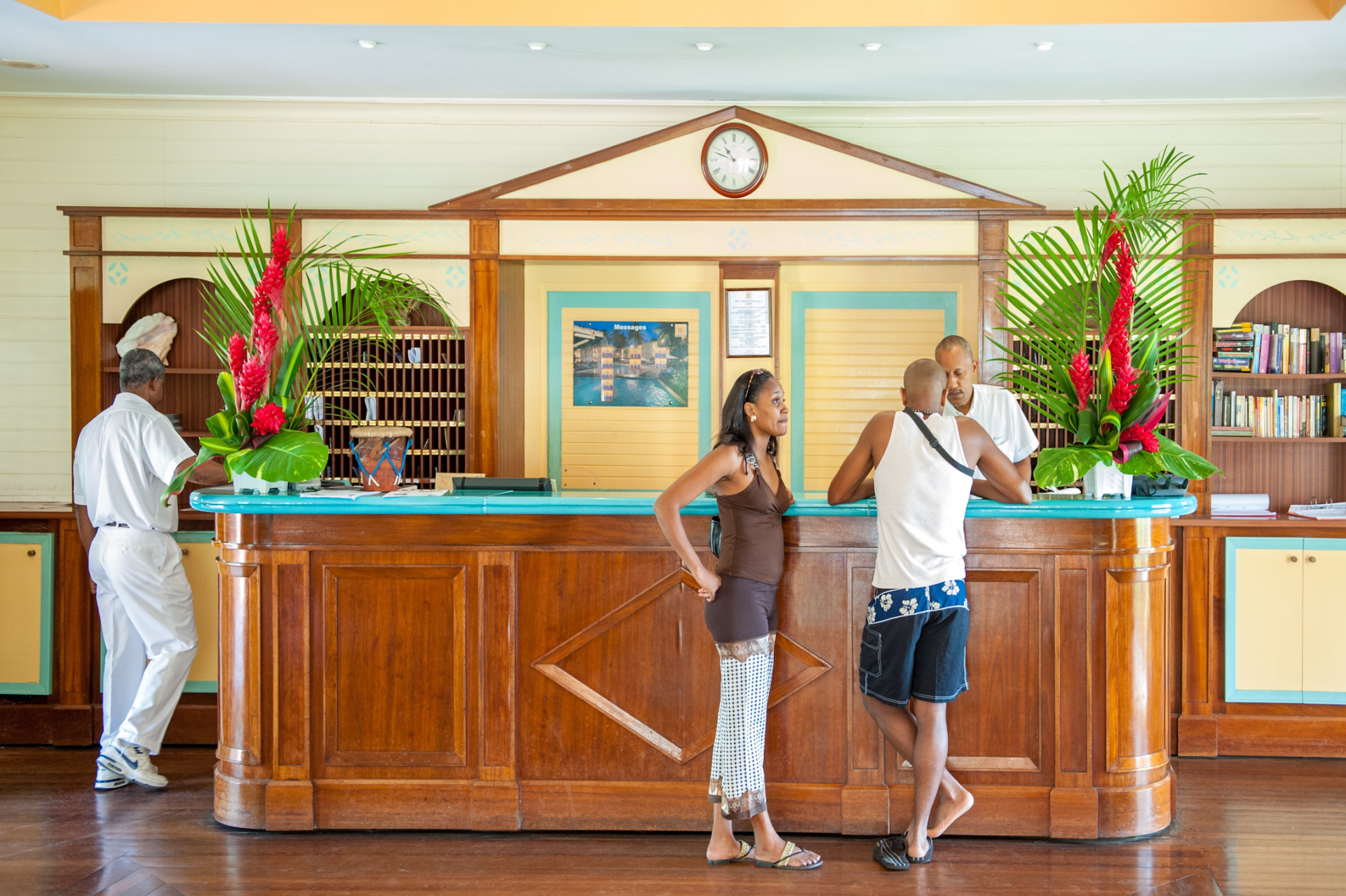 Hospitality industry concept - couple checking checking in in a hotel in the Caribbean.