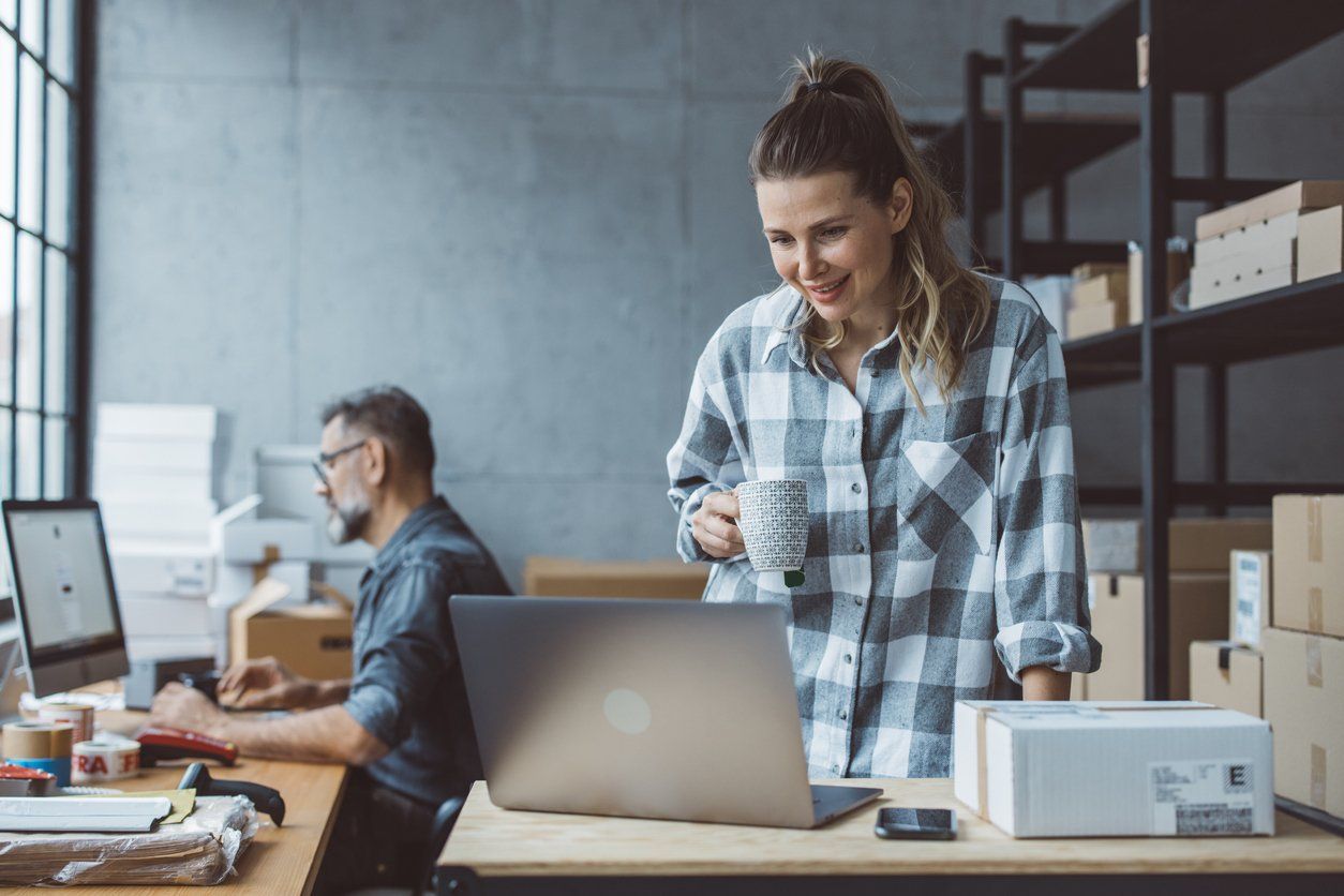 Couple who owns a small business updating their products and services online as a move towards digital transformation.