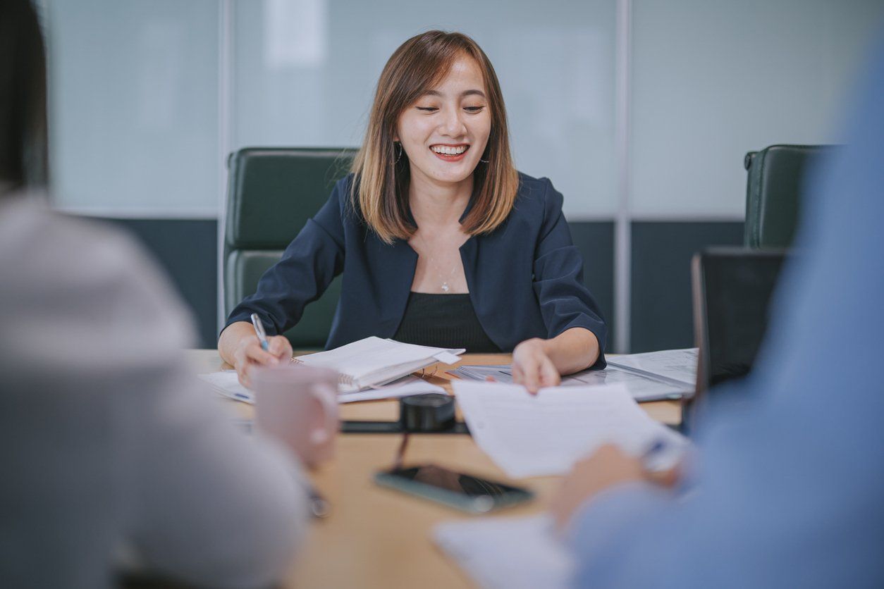 Female accountant speaking with her clients about the services they can avail from her accounting firm.