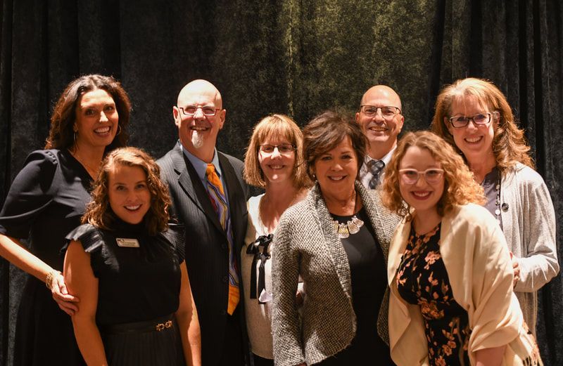 A group of people are posing for a picture together.