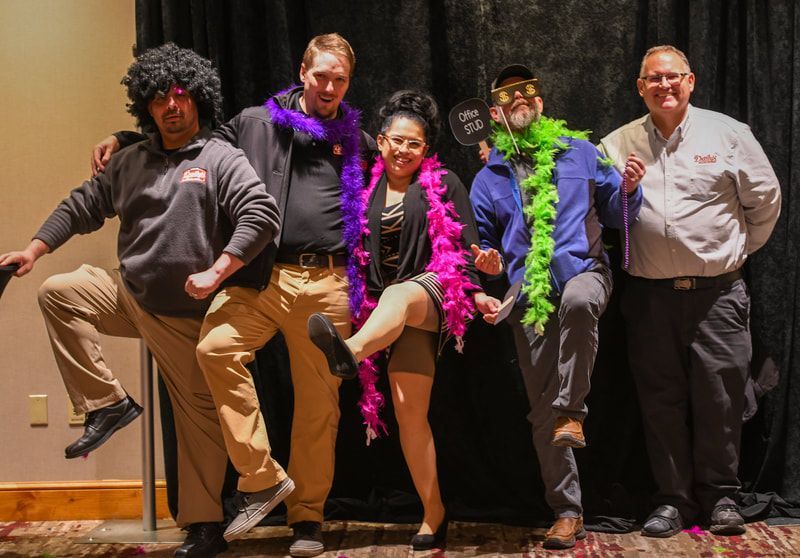 A group of people are posing for a picture in a photo booth.