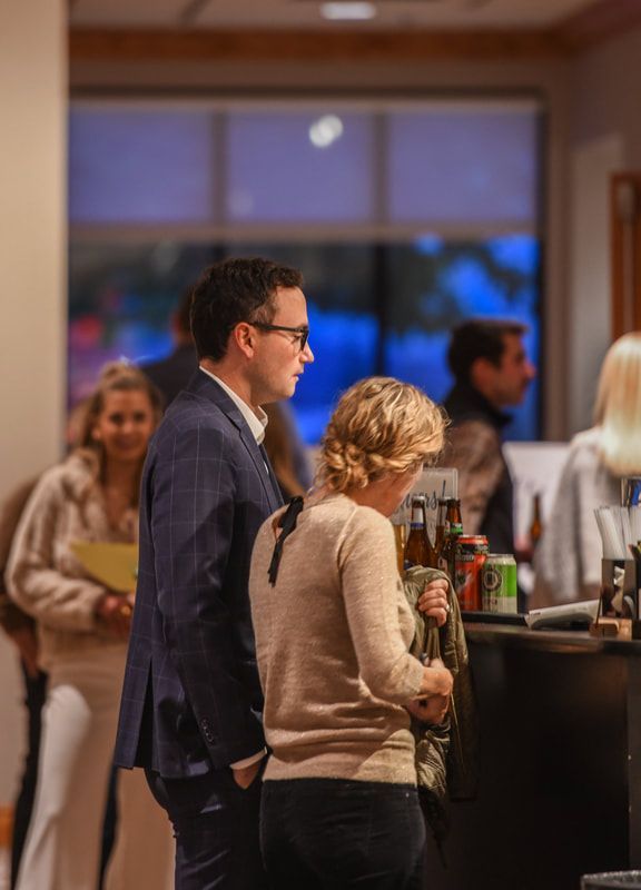 A man and a woman are standing next to each other in a room.