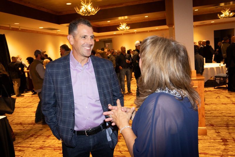 A man and a woman are talking to each other in a room.