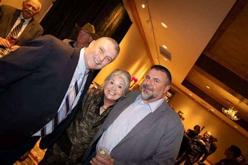 A group of people are posing for a picture in a room.