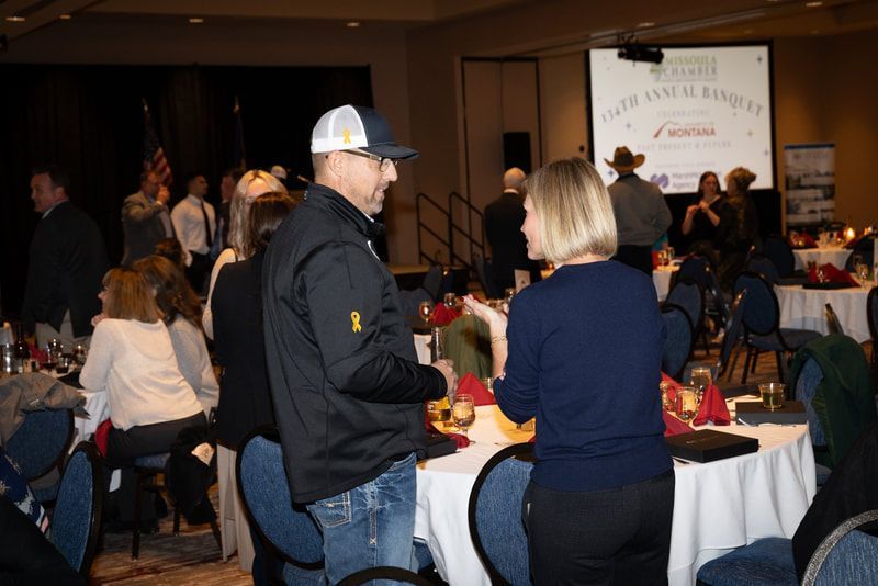 A group of people are sitting at tables in a room.