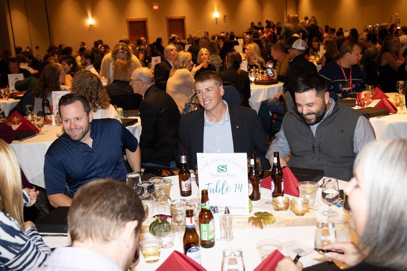 A large group of people are sitting at tables at a banquet.
