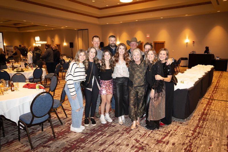 A group of people are posing for a picture in a room.