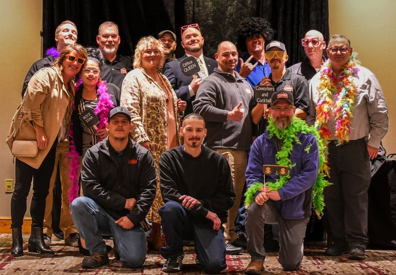 A group of people are posing for a picture in a room.