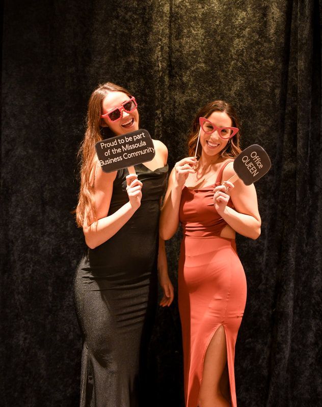 Two women are posing for a picture and one of them is wearing sunglasses