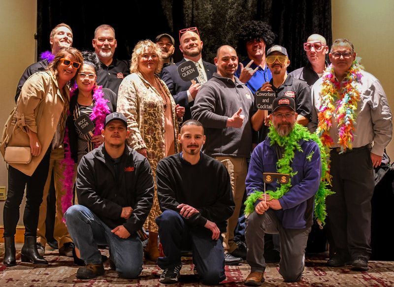 A group of people are posing for a picture in a room.