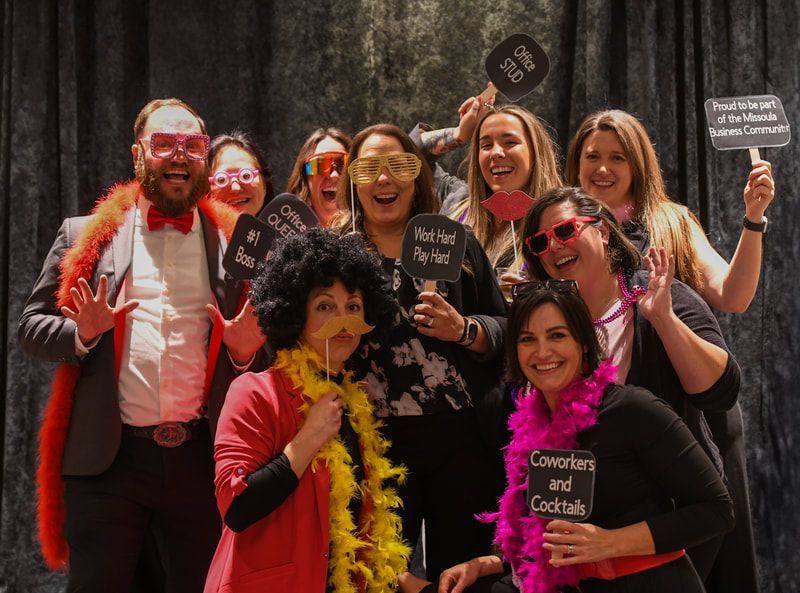 A group of people are posing for a picture in a photo booth.