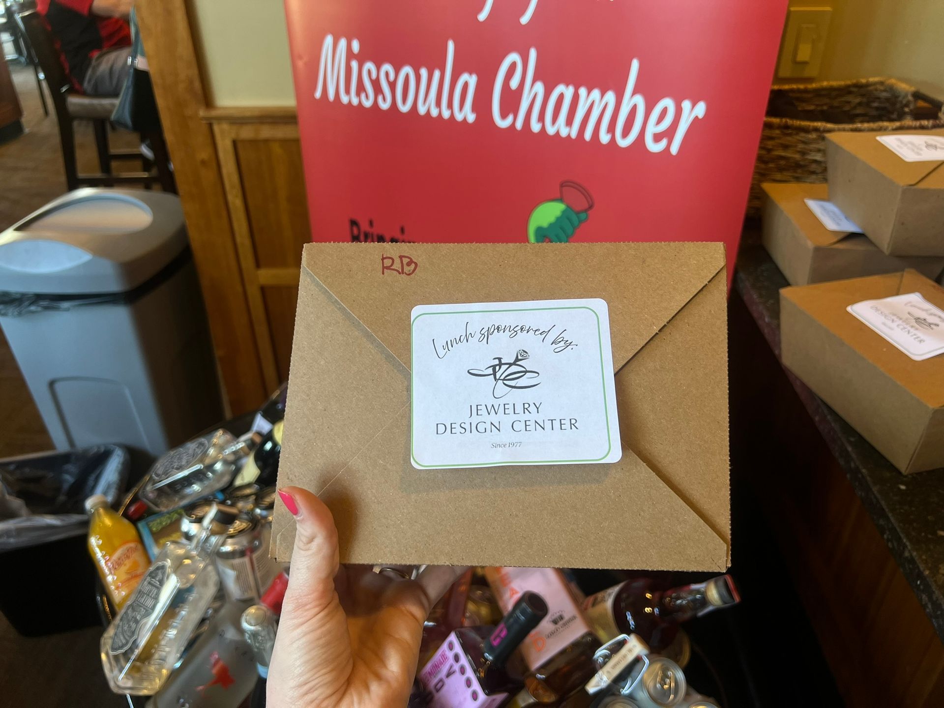 A person is holding an envelope that says missoula chamber