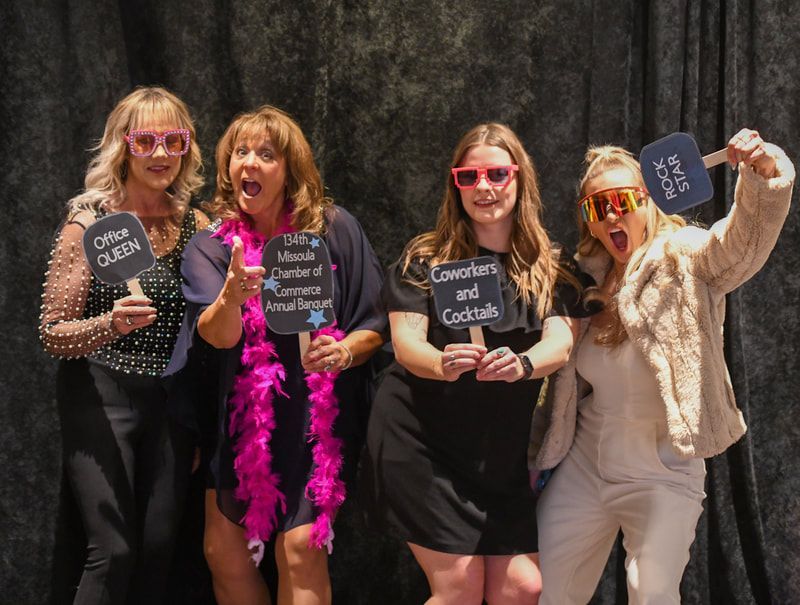 A group of women standing next to each other holding signs.