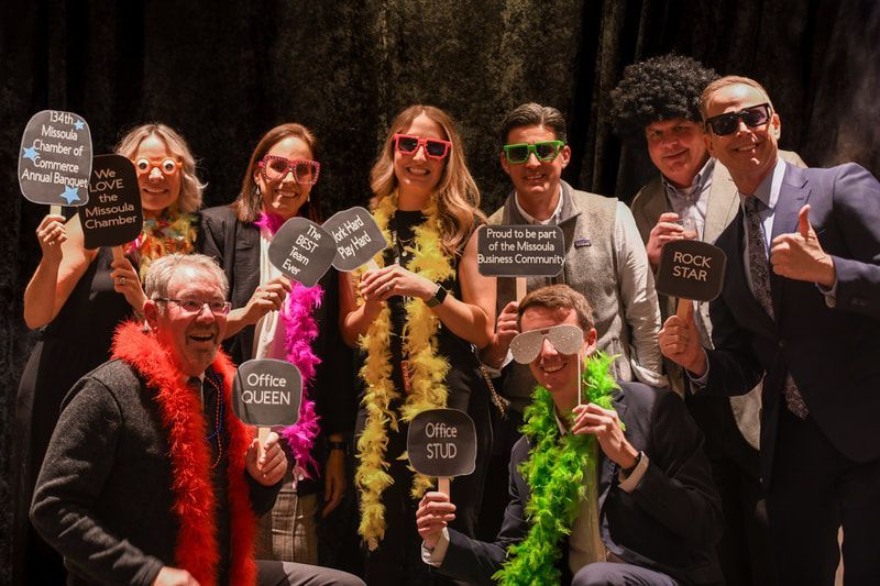 A group of people are posing for a picture while holding signs.