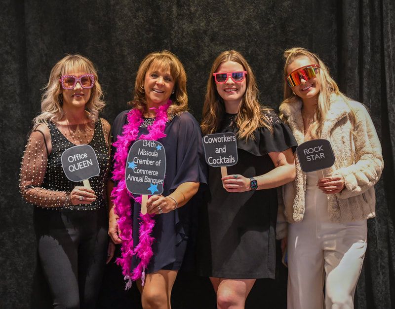 A group of women standing next to each other holding signs.