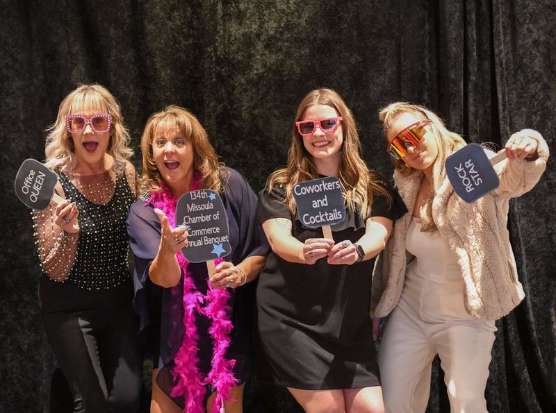 A group of women standing next to each other holding signs.