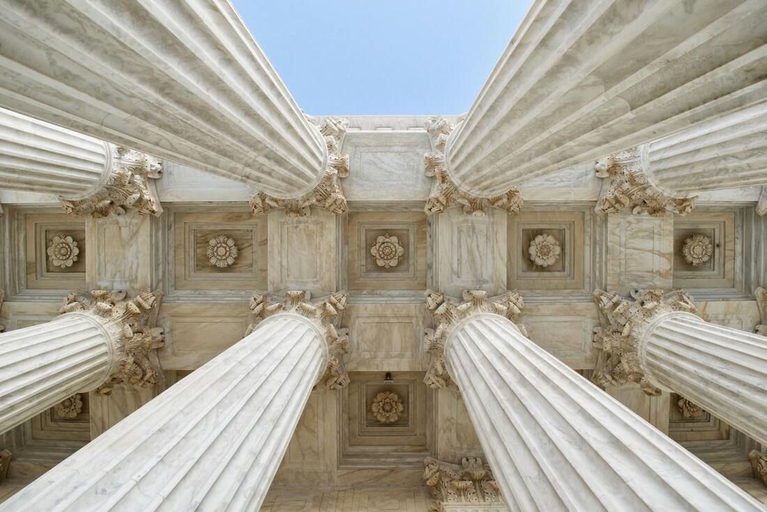 Looking up at the columns of the supreme court building.