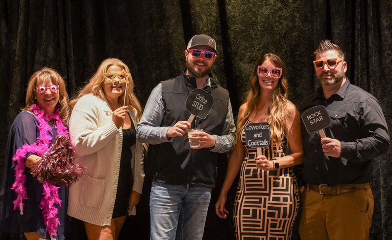 A group of people are posing for a picture in a photo booth.