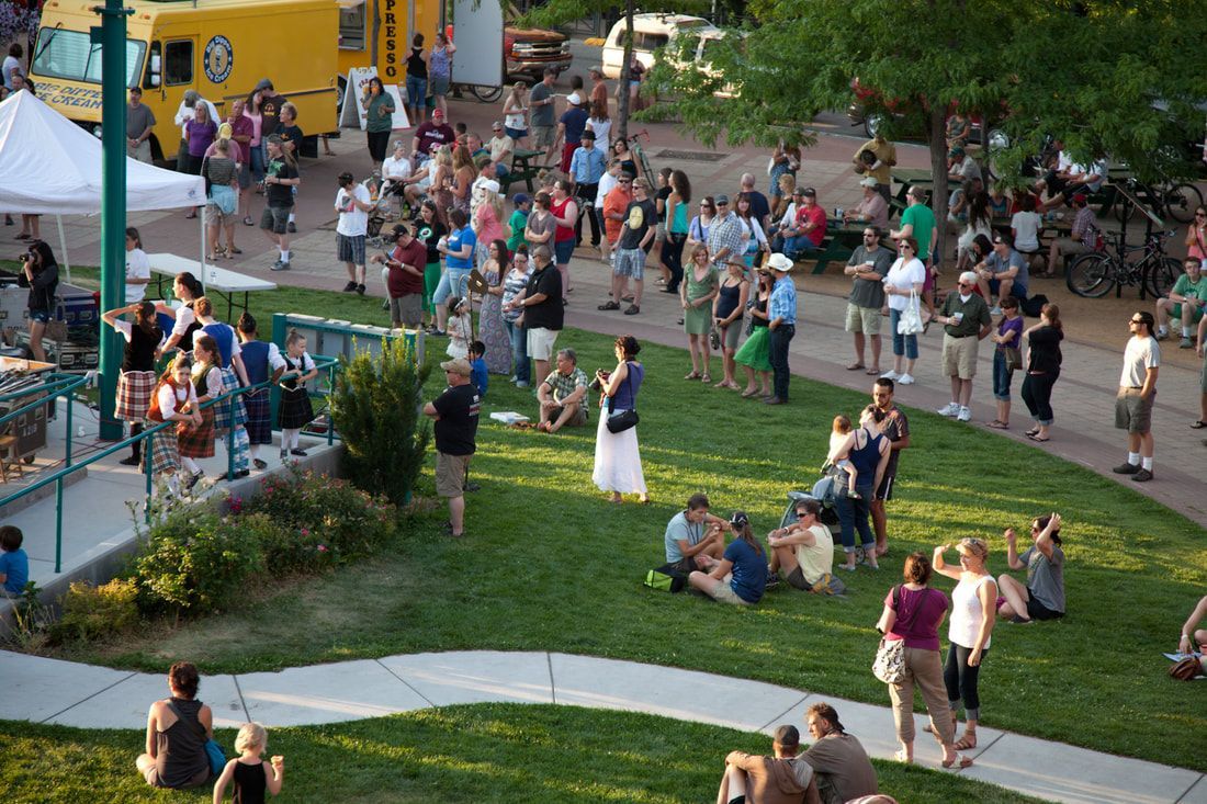 A large group of people are gathered in a park.