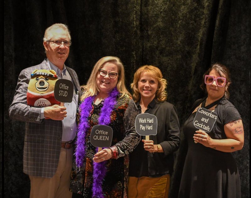 A group of people standing next to each other holding signs.