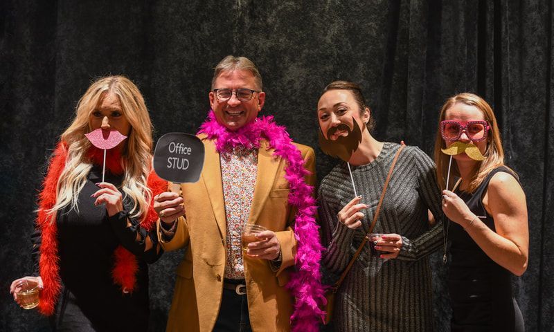 A group of people are posing for a picture in a photo booth.