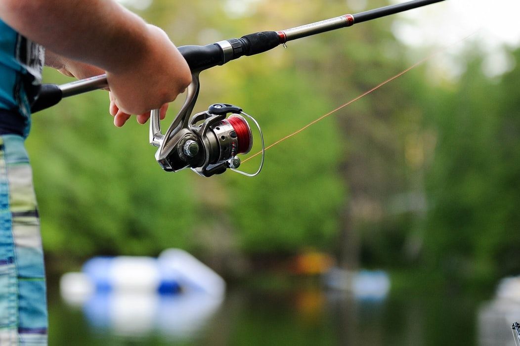 A person is holding a fishing rod in their hand.