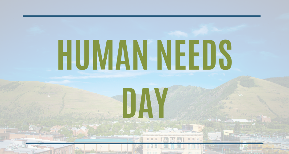 A poster for human needs day with a city in the background.