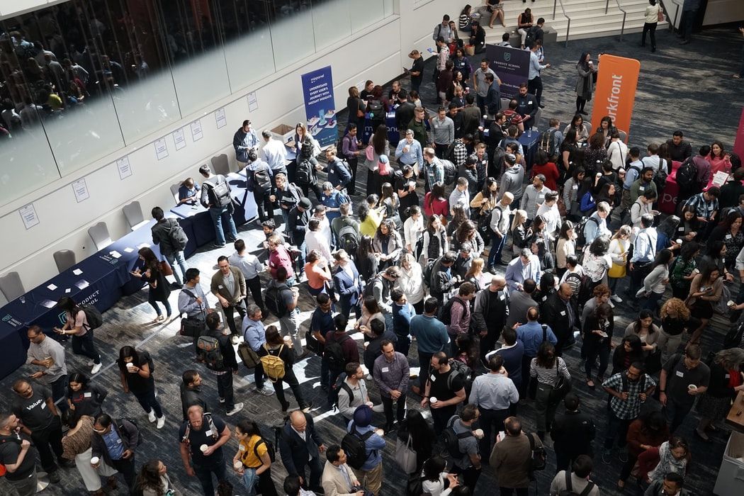A large group of people are standing in a room.