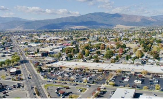 An aerial view of a city with mountains in the background.