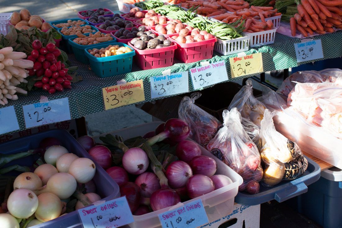 A variety of fruits and vegetables are for sale at a farmers market