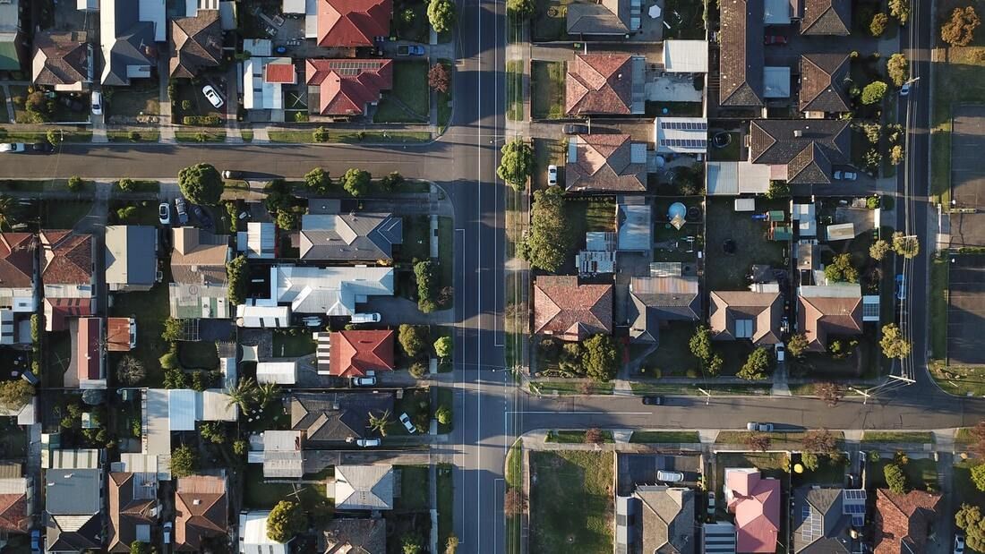 An aerial view of a residential area with lots of houses and trees.