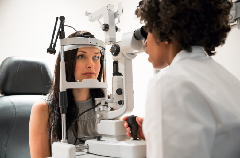 A woman is getting her eyes examined by an ophthalmologist.
