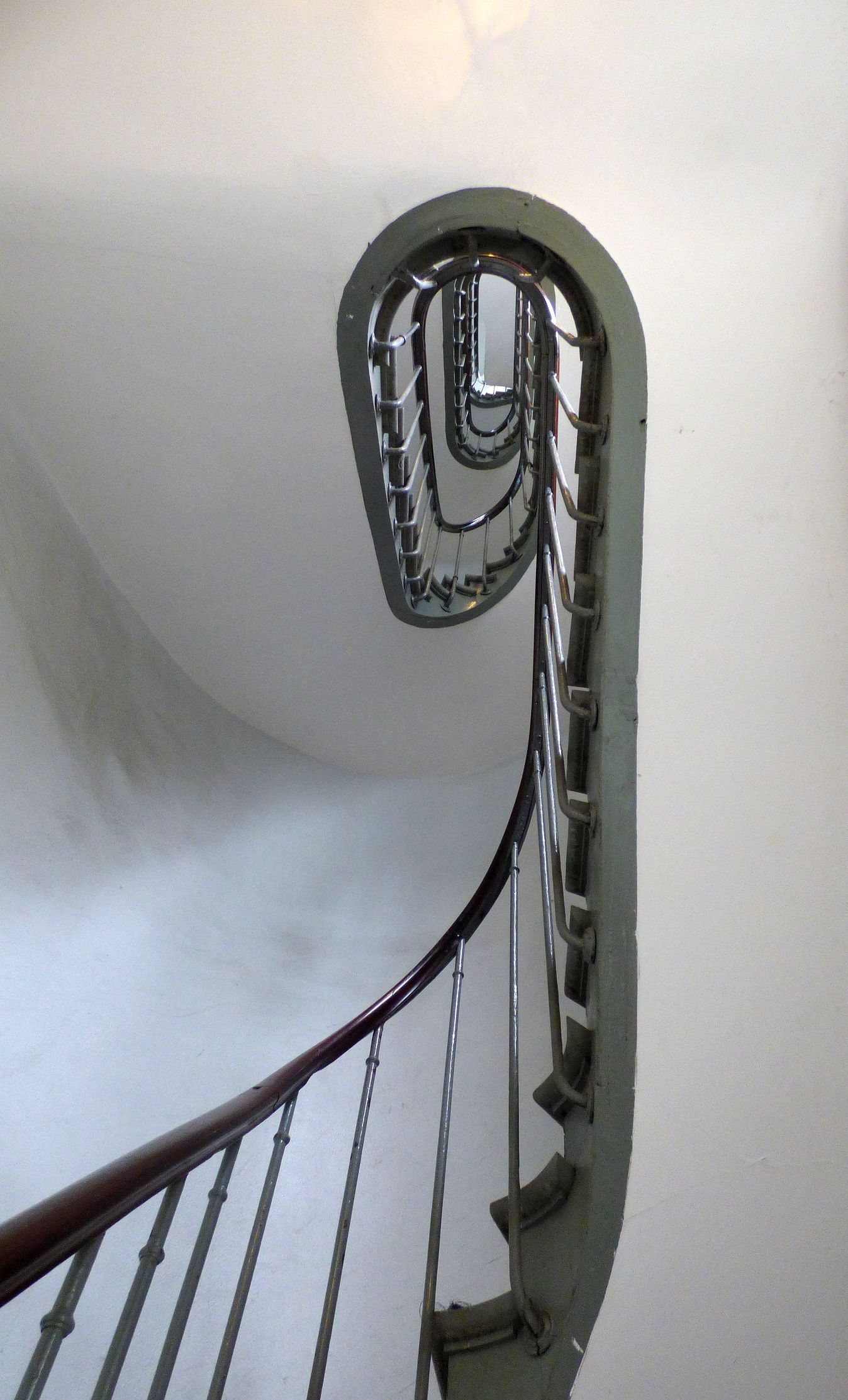 Spiral white staircase with steel black balustrading.