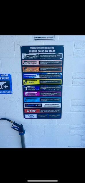 A hose is attached to a wall in a car wash.