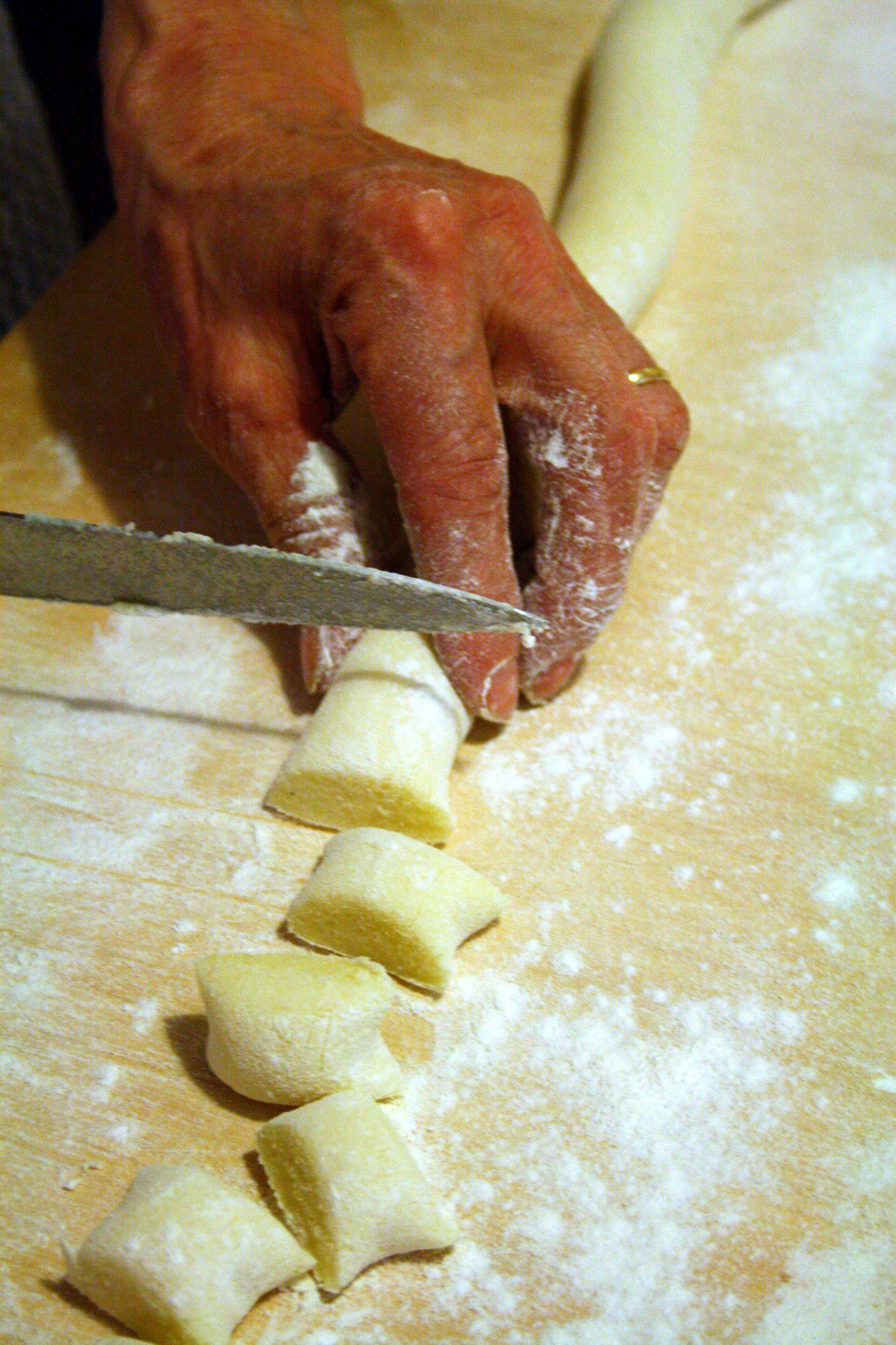Man cutting pasta