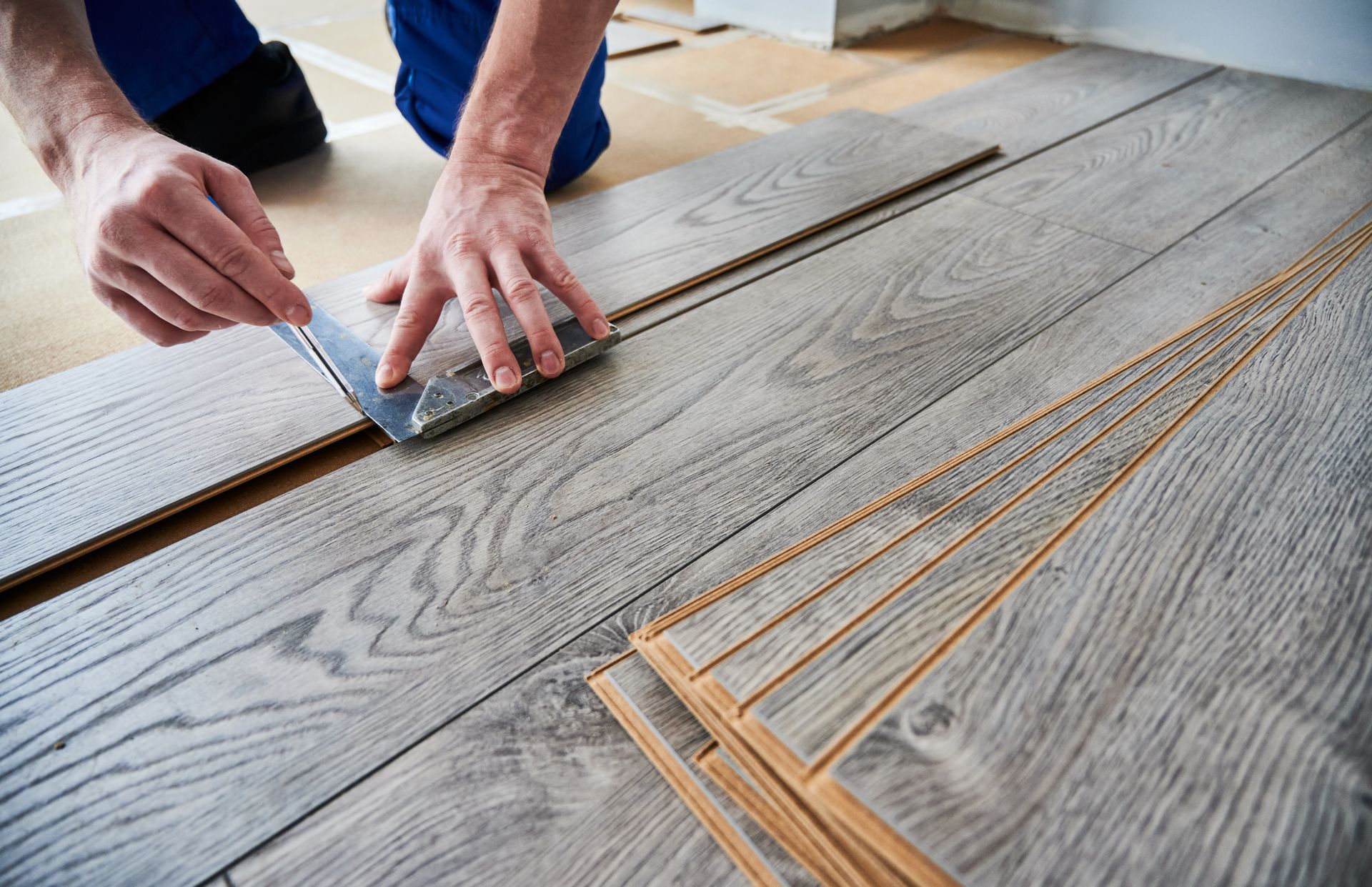 Installing luxury vinyl plank wood flooring.