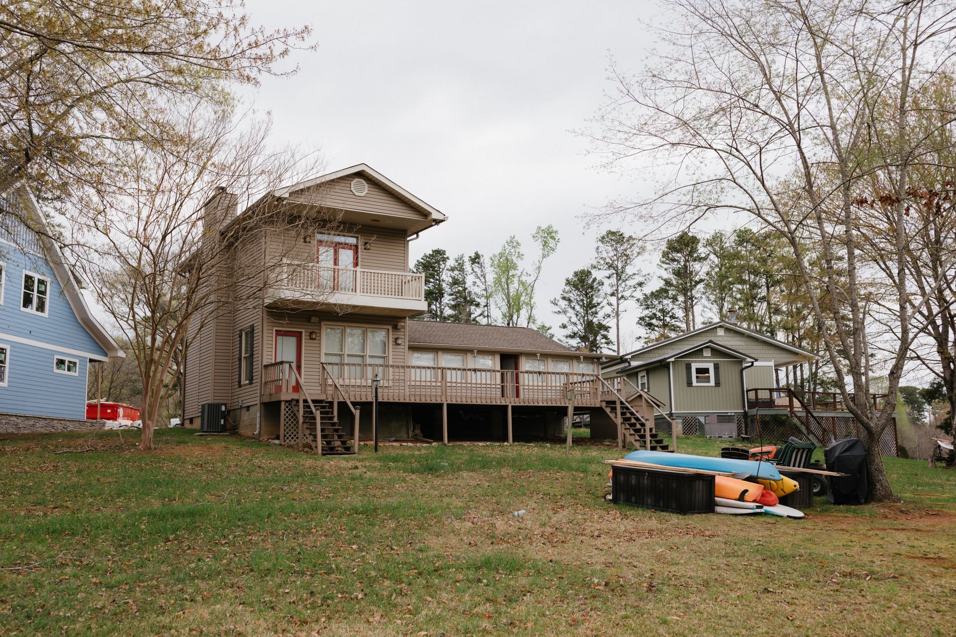 A large house is sitting in the middle of a grassy field.